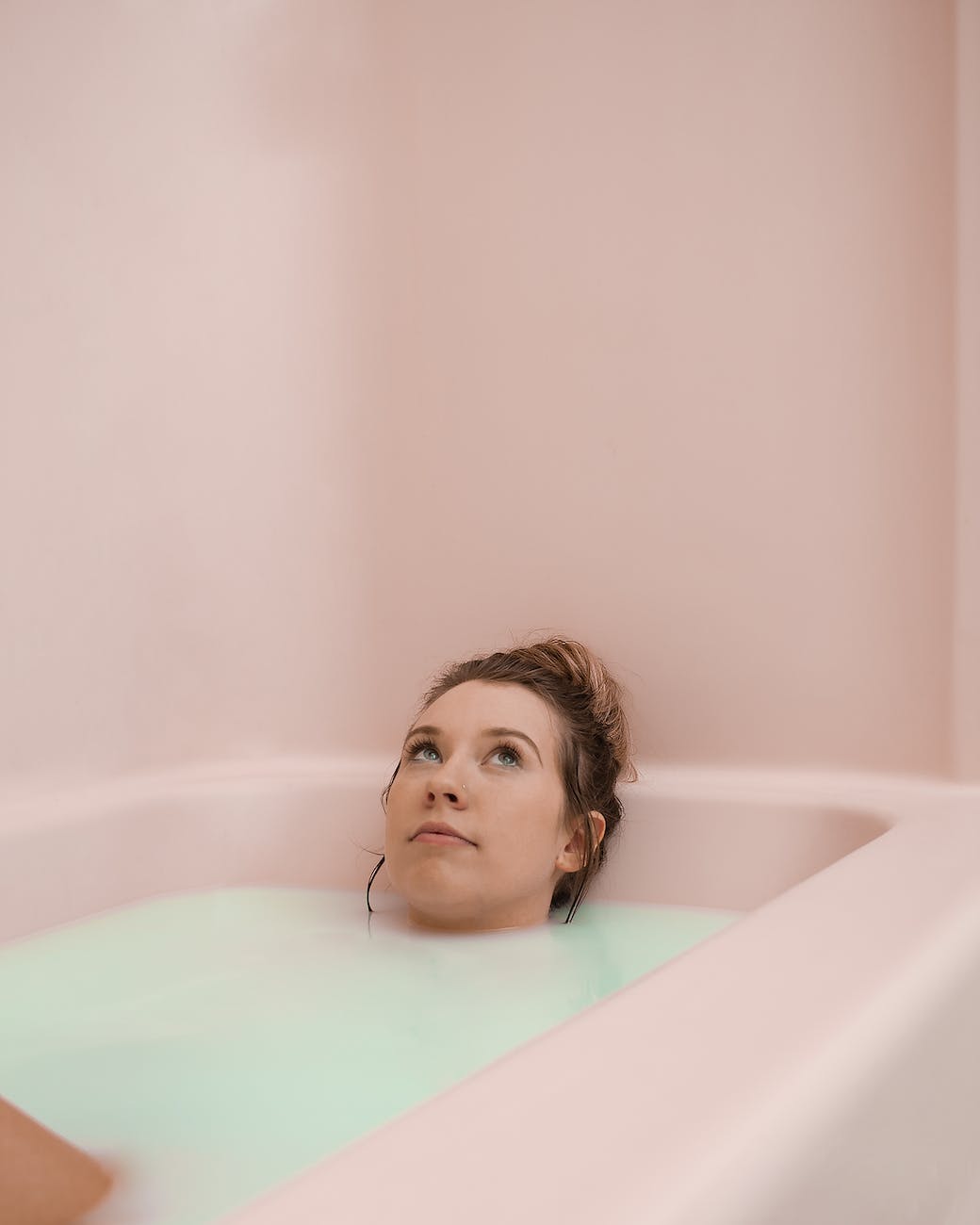 woman in bathtub with water